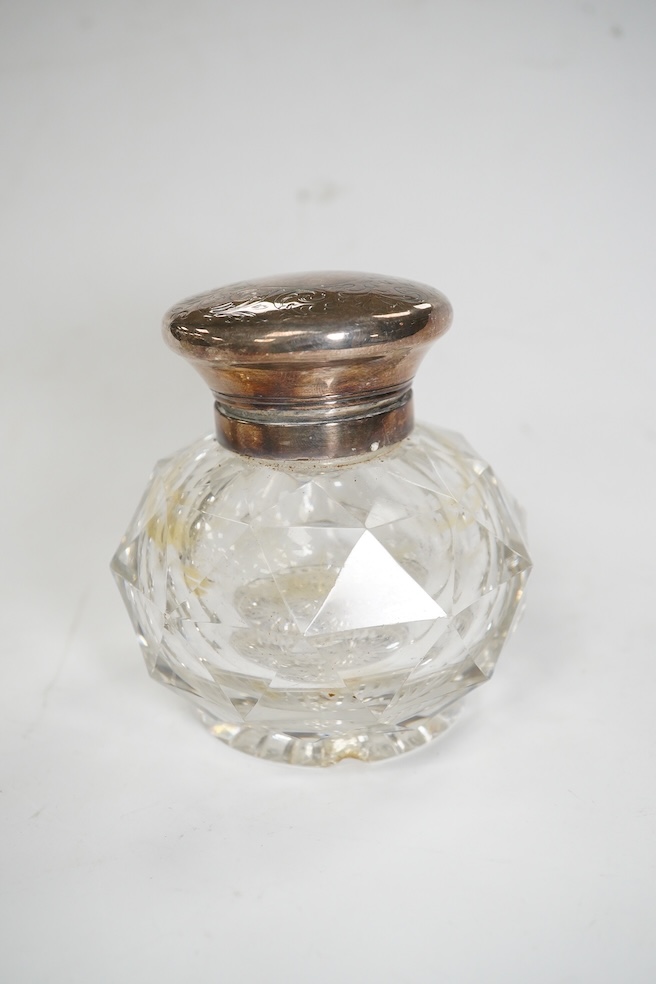 Four assorted mounted glass scent bottles, including three with silver mounts, tallest 11.9cm. Condition - poor